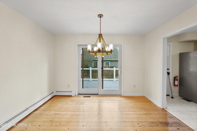 unfurnished dining area featuring a baseboard heating unit, a chandelier, and light wood-type flooring