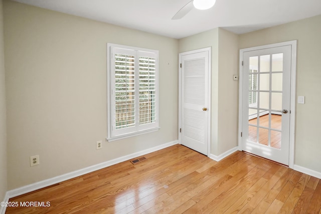 unfurnished room featuring ceiling fan, a baseboard radiator, and light hardwood / wood-style flooring