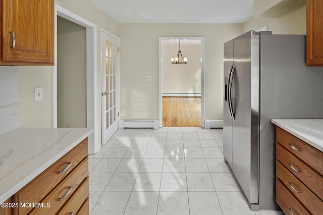 kitchen with a baseboard heating unit, stainless steel fridge with ice dispenser, and an inviting chandelier