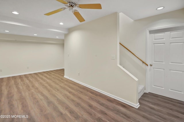 basement with ceiling fan and hardwood / wood-style floors