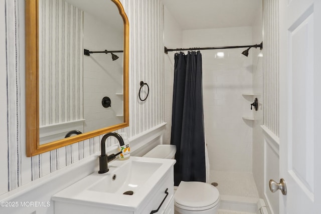 bathroom featuring toilet, vanity, and curtained shower