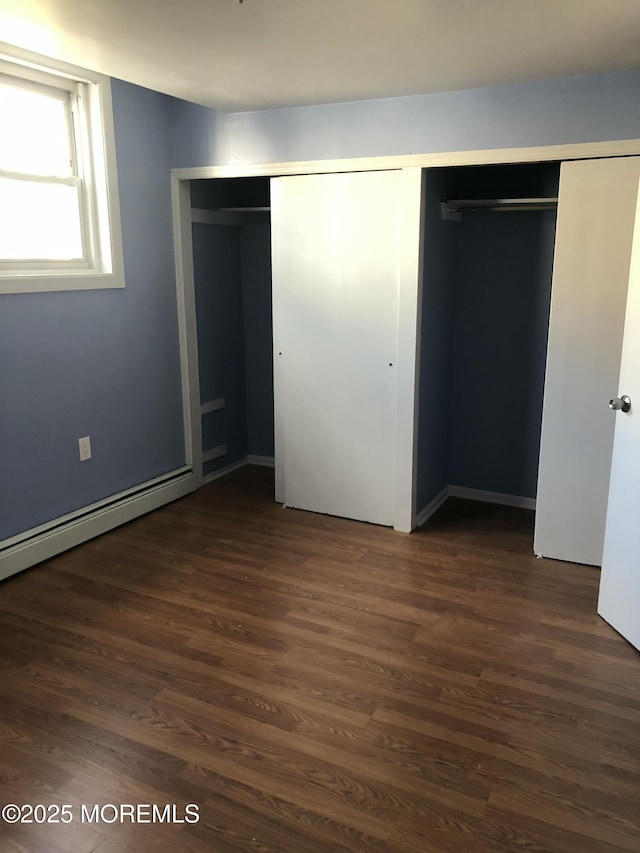 unfurnished bedroom featuring a closet and dark hardwood / wood-style floors