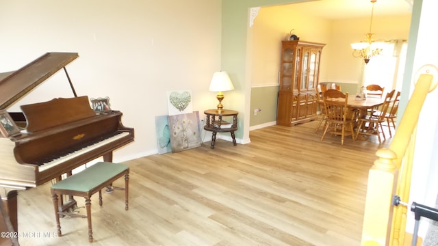 misc room featuring a chandelier and light hardwood / wood-style floors