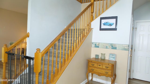 stairway featuring wood-type flooring