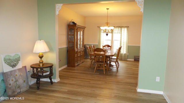 dining room featuring light hardwood / wood-style flooring and a notable chandelier