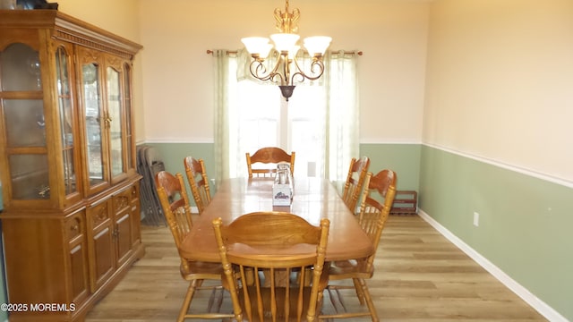 dining area featuring a notable chandelier and light hardwood / wood-style floors