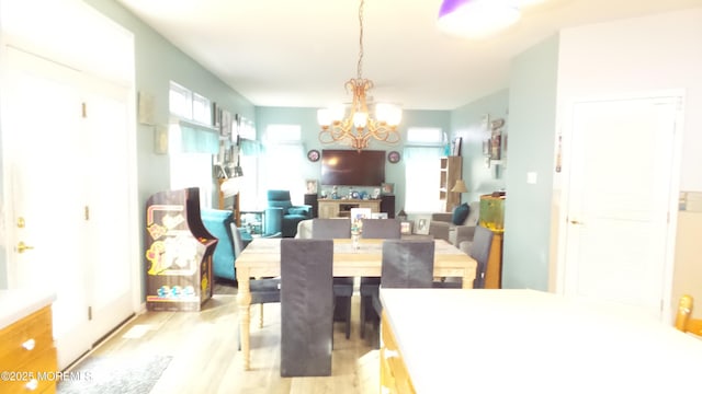 dining room featuring a notable chandelier and light wood-type flooring