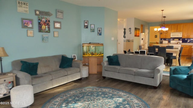 living room featuring dark wood-type flooring and a chandelier