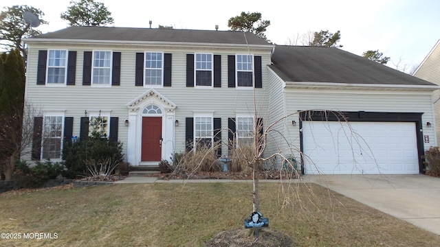 colonial inspired home featuring a front yard and a garage