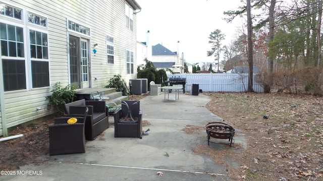 view of patio featuring cooling unit, a fire pit, and grilling area