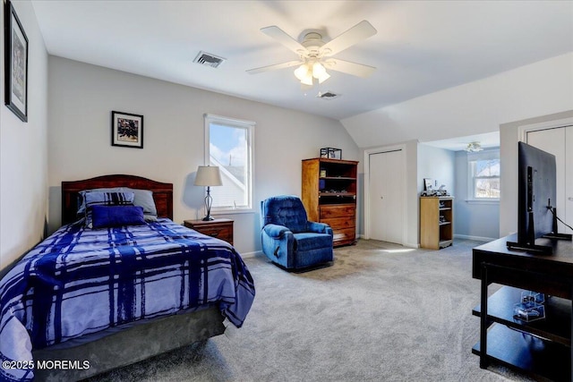 carpeted bedroom with a ceiling fan, visible vents, and baseboards