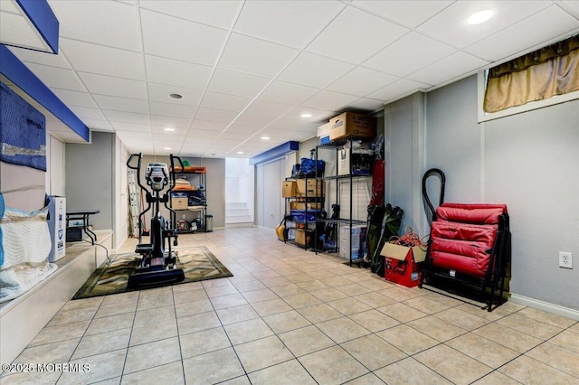 workout area featuring a paneled ceiling, light tile patterned floors, baseboards, and recessed lighting