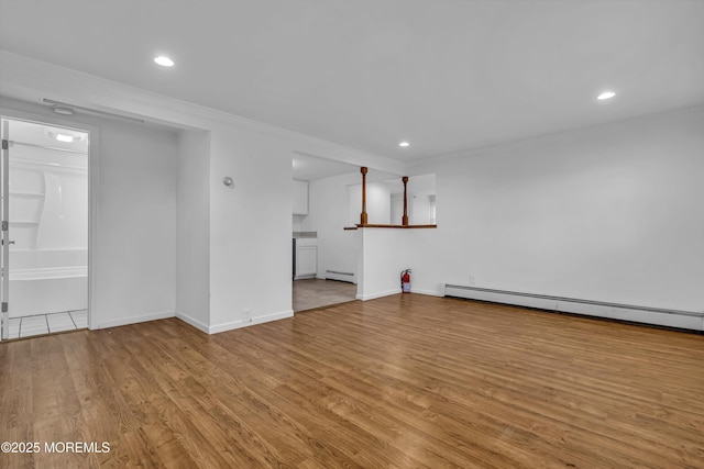 interior space featuring light hardwood / wood-style floors and a baseboard radiator