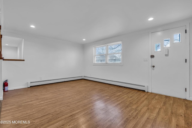 foyer with a baseboard radiator and light hardwood / wood-style floors