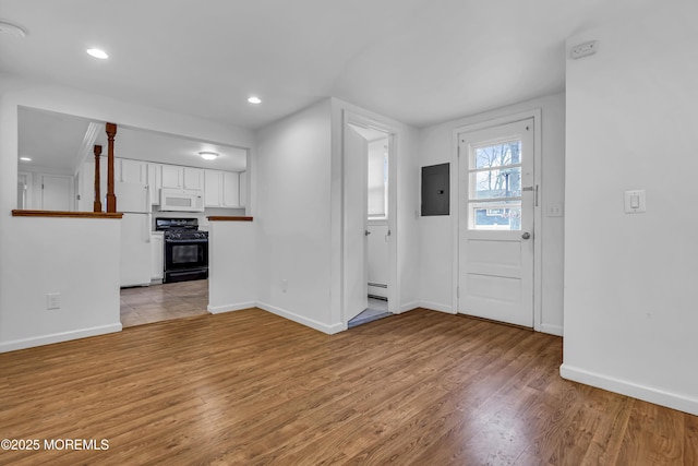 entrance foyer with light hardwood / wood-style floors, a baseboard heating unit, and electric panel