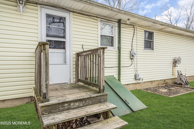 entrance to property with a lawn