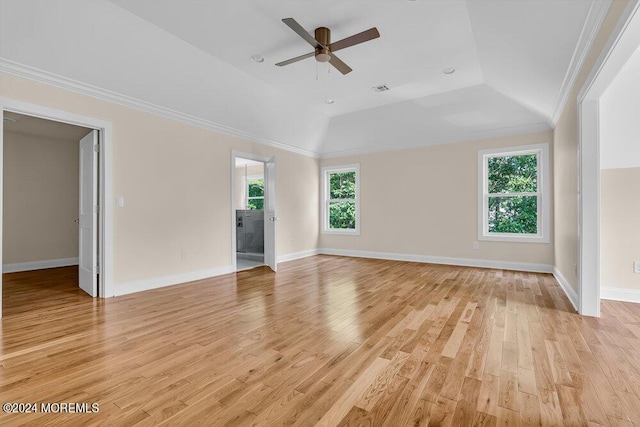 empty room with ceiling fan, a wealth of natural light, lofted ceiling, and ornamental molding