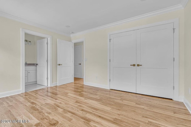 unfurnished bedroom featuring light hardwood / wood-style floors, ensuite bathroom, a closet, and ornamental molding