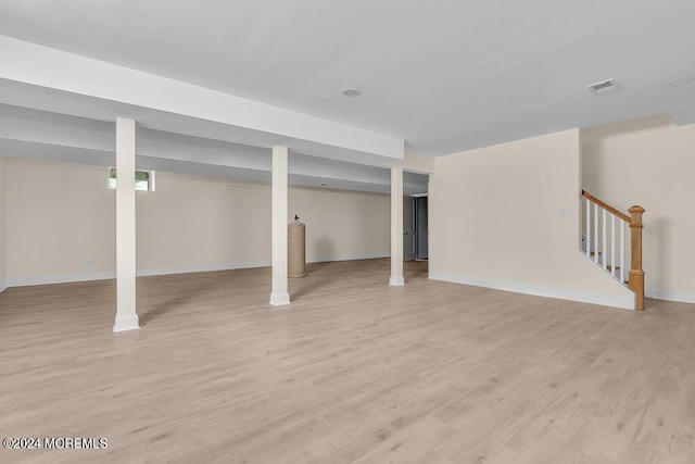 basement with light hardwood / wood-style flooring