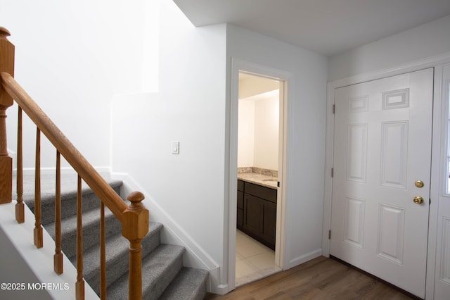 stairs with a water view and hardwood / wood-style flooring