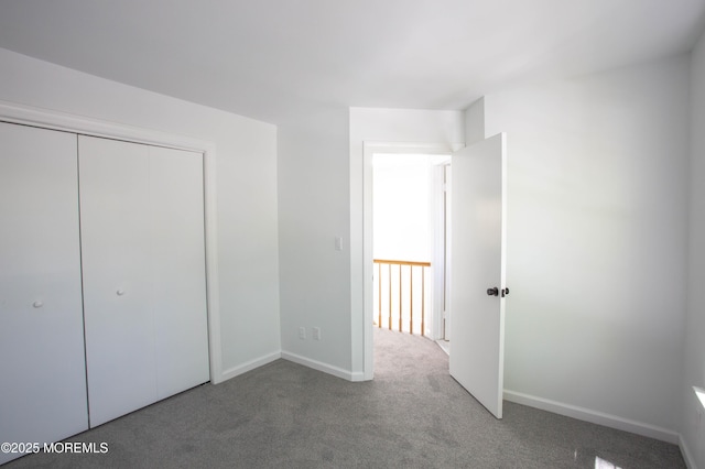 unfurnished bedroom with a closet and carpet flooring