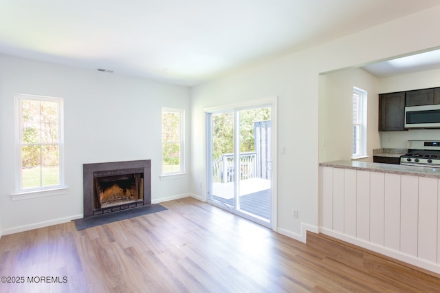 unfurnished living room with light hardwood / wood-style flooring