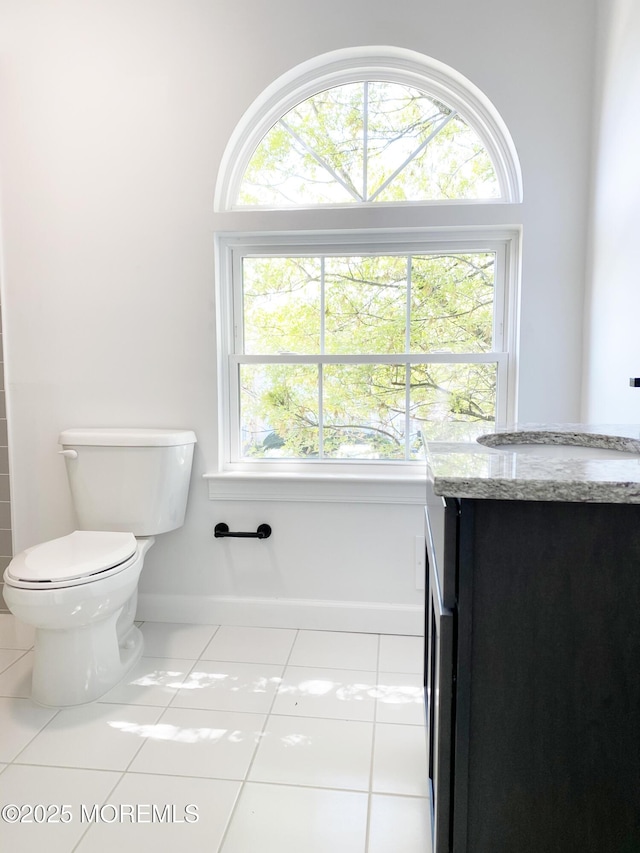 bathroom with tile patterned floors, vanity, and toilet