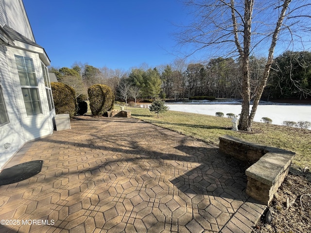 view of patio featuring a water view