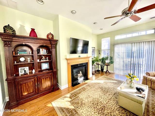 living room with ceiling fan and light hardwood / wood-style floors