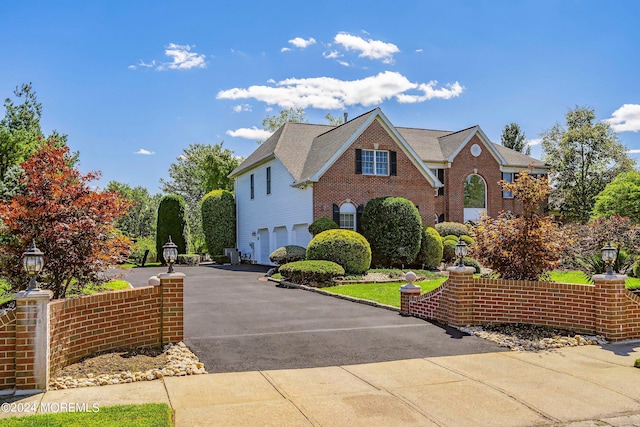 front of property featuring a garage and central AC