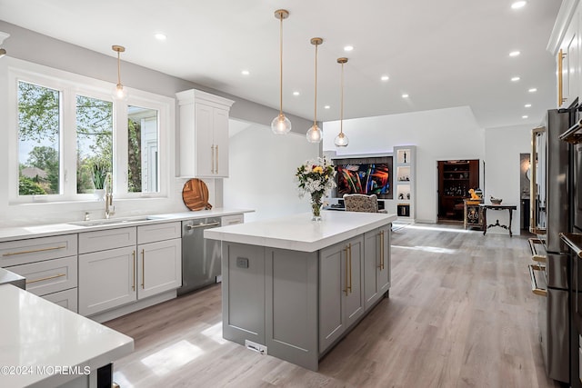 kitchen with decorative light fixtures, dishwasher, gray cabinets, a center island, and sink