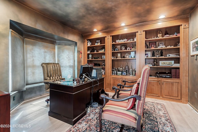 office featuring built in shelves and light hardwood / wood-style floors