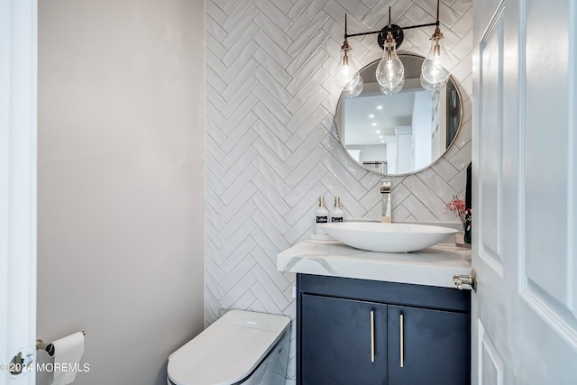 bathroom featuring backsplash, toilet, and vanity