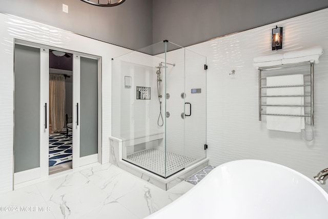 bathroom featuring separate shower and tub