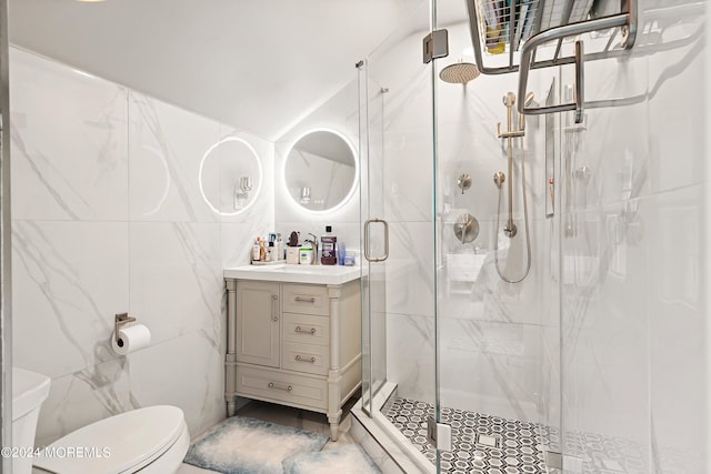 bathroom with vanity, toilet, tile walls, and an enclosed shower