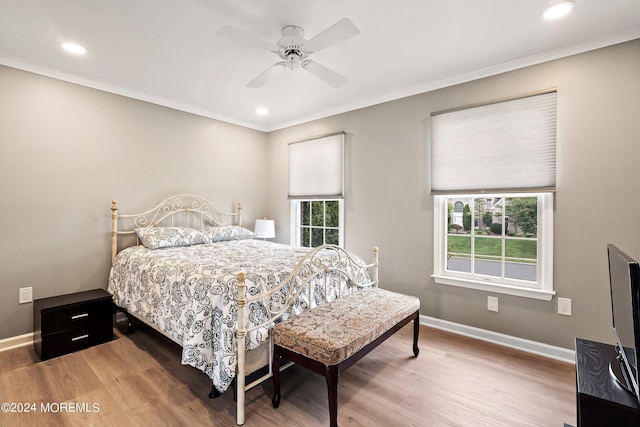 bedroom with ceiling fan, hardwood / wood-style floors, and ornamental molding