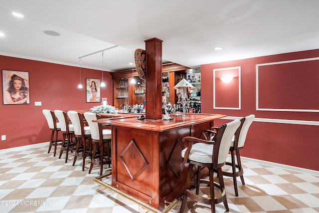 bar with ornamental molding and pendant lighting