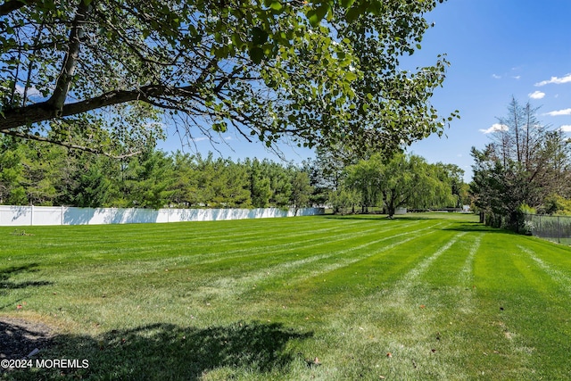 exterior space with a water view and a lawn