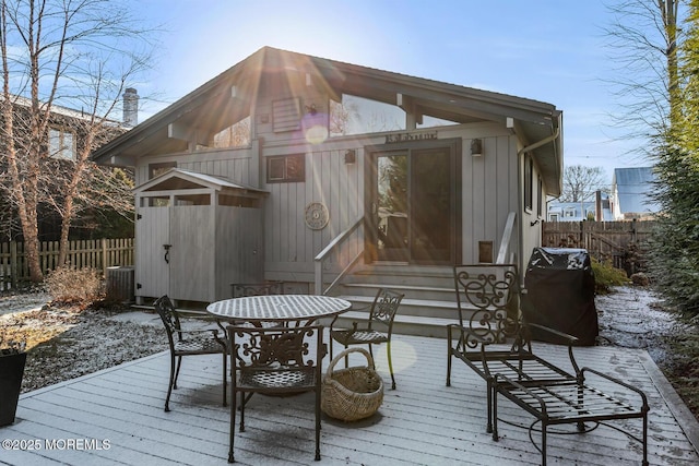 wooden terrace with a grill and central air condition unit