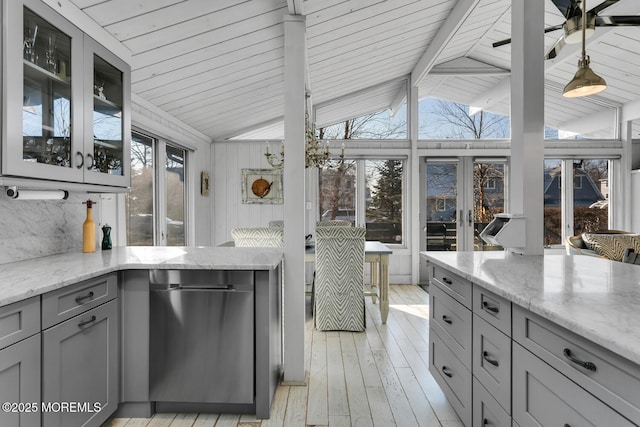 kitchen with gray cabinetry, light hardwood / wood-style floors, vaulted ceiling with beams, and light stone countertops