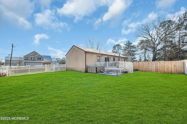 rear view of house with a deck and a lawn