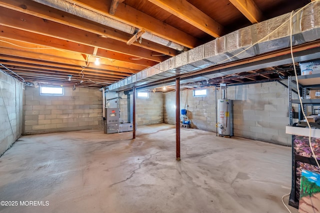 basement featuring heating unit and water heater