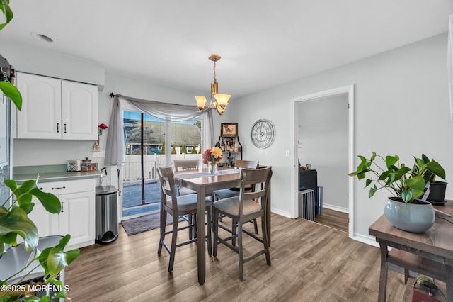 dining room with an inviting chandelier and light hardwood / wood-style floors