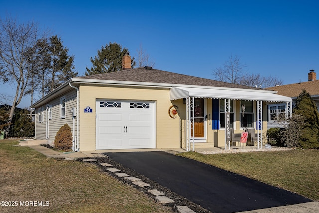 ranch-style house featuring a front yard, a porch, and a garage