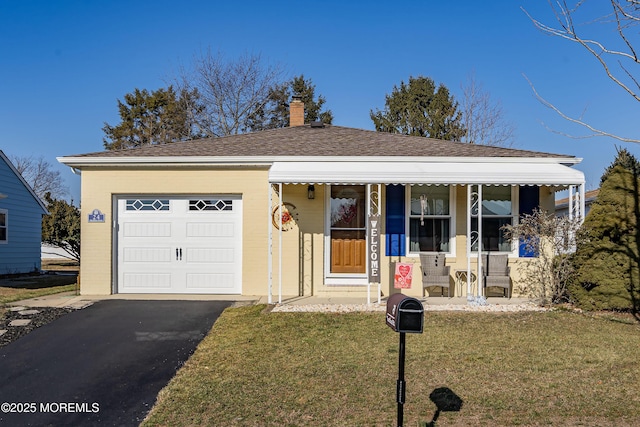 view of front of home featuring a front lawn, a porch, and a garage