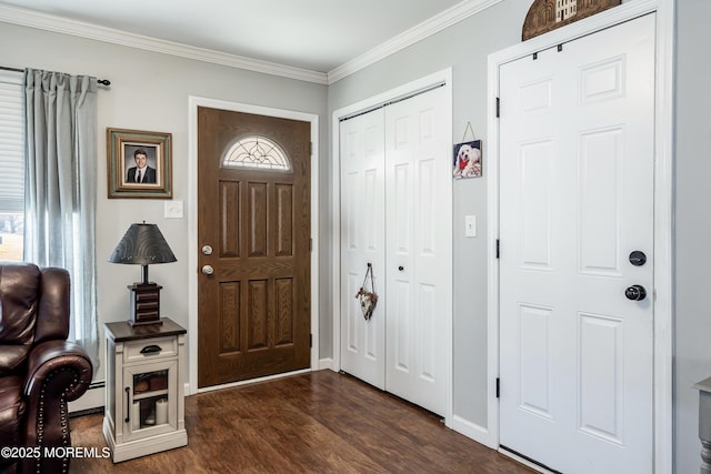 foyer entrance with a baseboard heating unit, dark hardwood / wood-style flooring, and crown molding