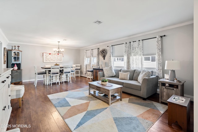 living room with a chandelier, crown molding, and dark hardwood / wood-style floors