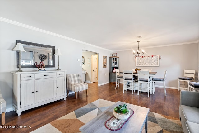 living room with dark hardwood / wood-style flooring, crown molding, and a chandelier