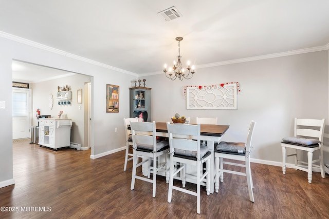 dining room featuring dark hardwood / wood-style floors, a chandelier, and ornamental molding