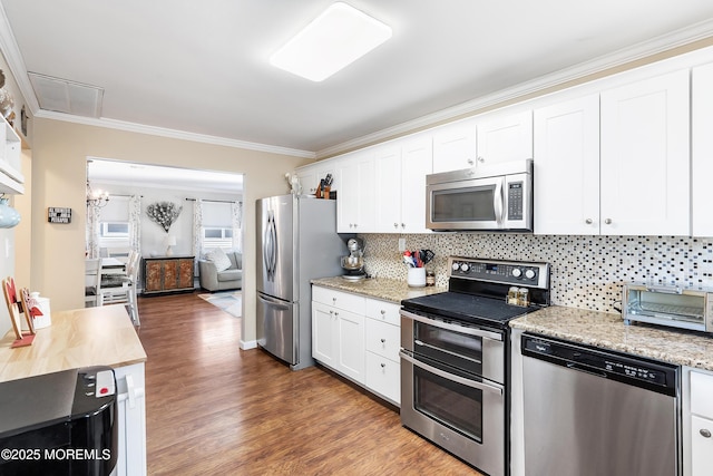 kitchen featuring white cabinetry, stainless steel appliances, decorative backsplash, dark hardwood / wood-style flooring, and crown molding